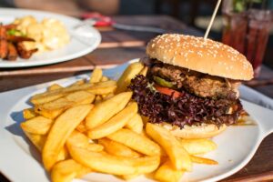 Burger mit Pommes aus der Outdoorküche mit Grill