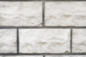 Textur einer weißen Mauer, eines Betonzauns, Nahaufnahme.